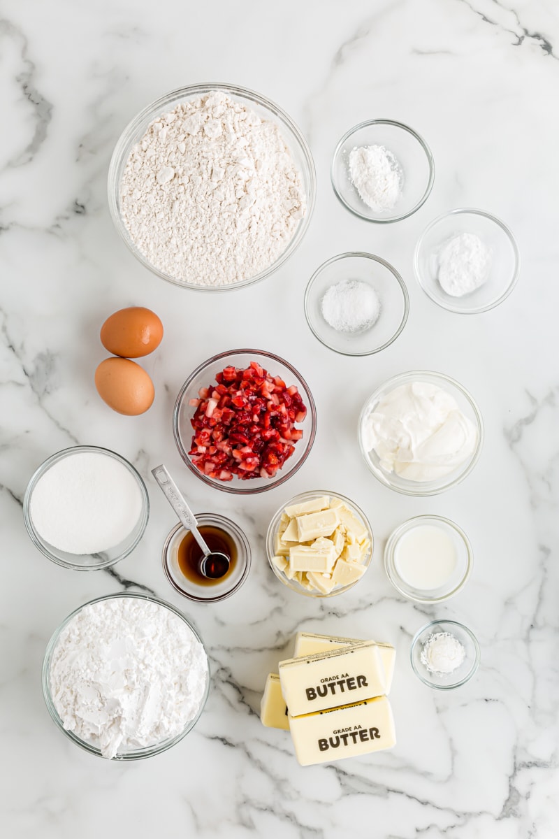 Overhead view of ingredients for strawberry cupcakes with white chocolate frosting
