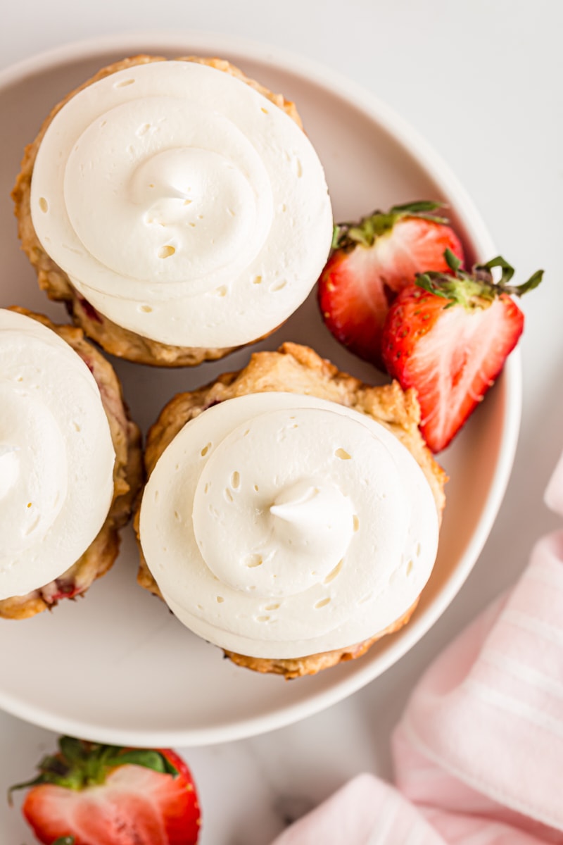 Overhead view of 3 strawberry cupcakes on plate