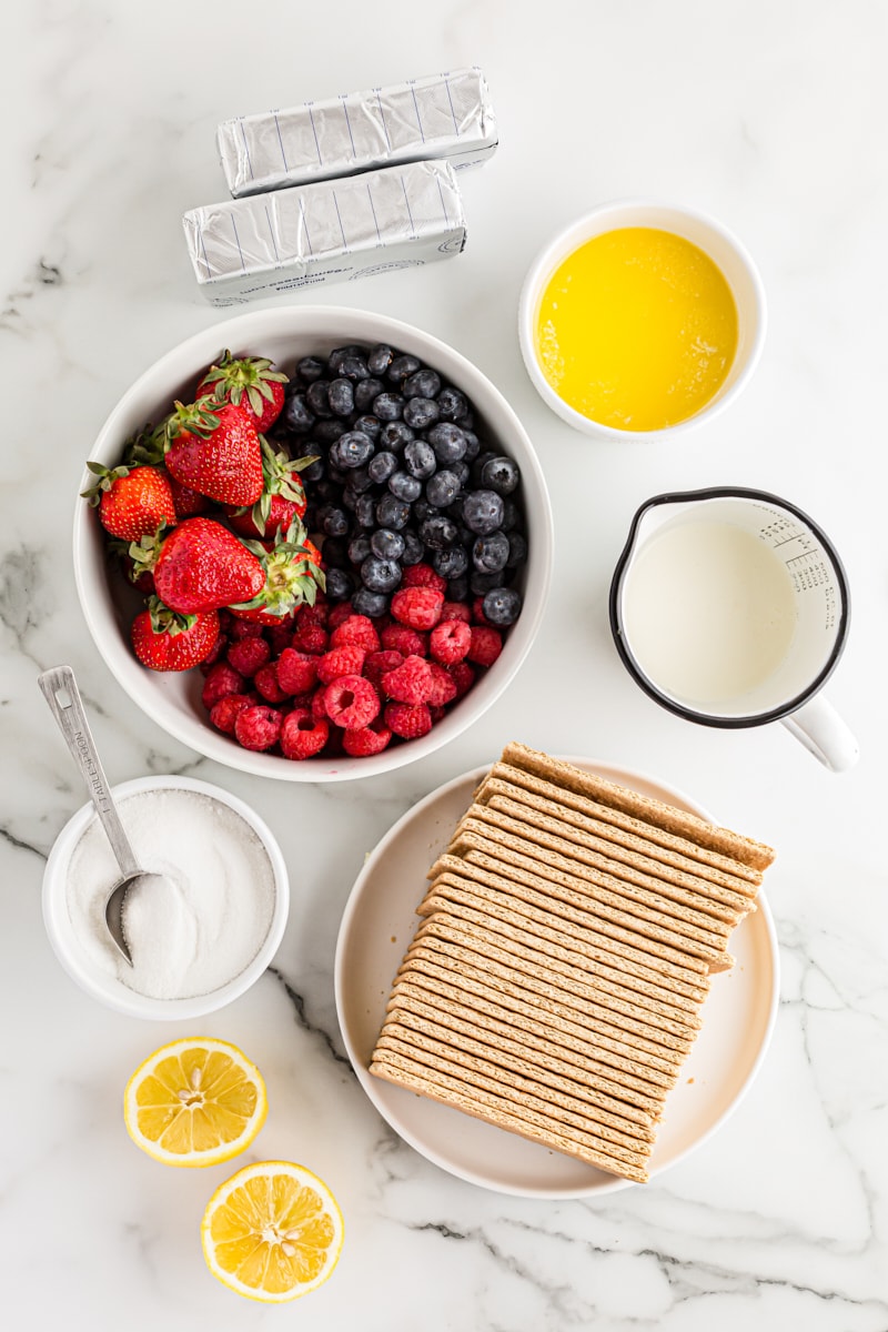 Overhead view of ingredients for triple berry no-bake cheesecake