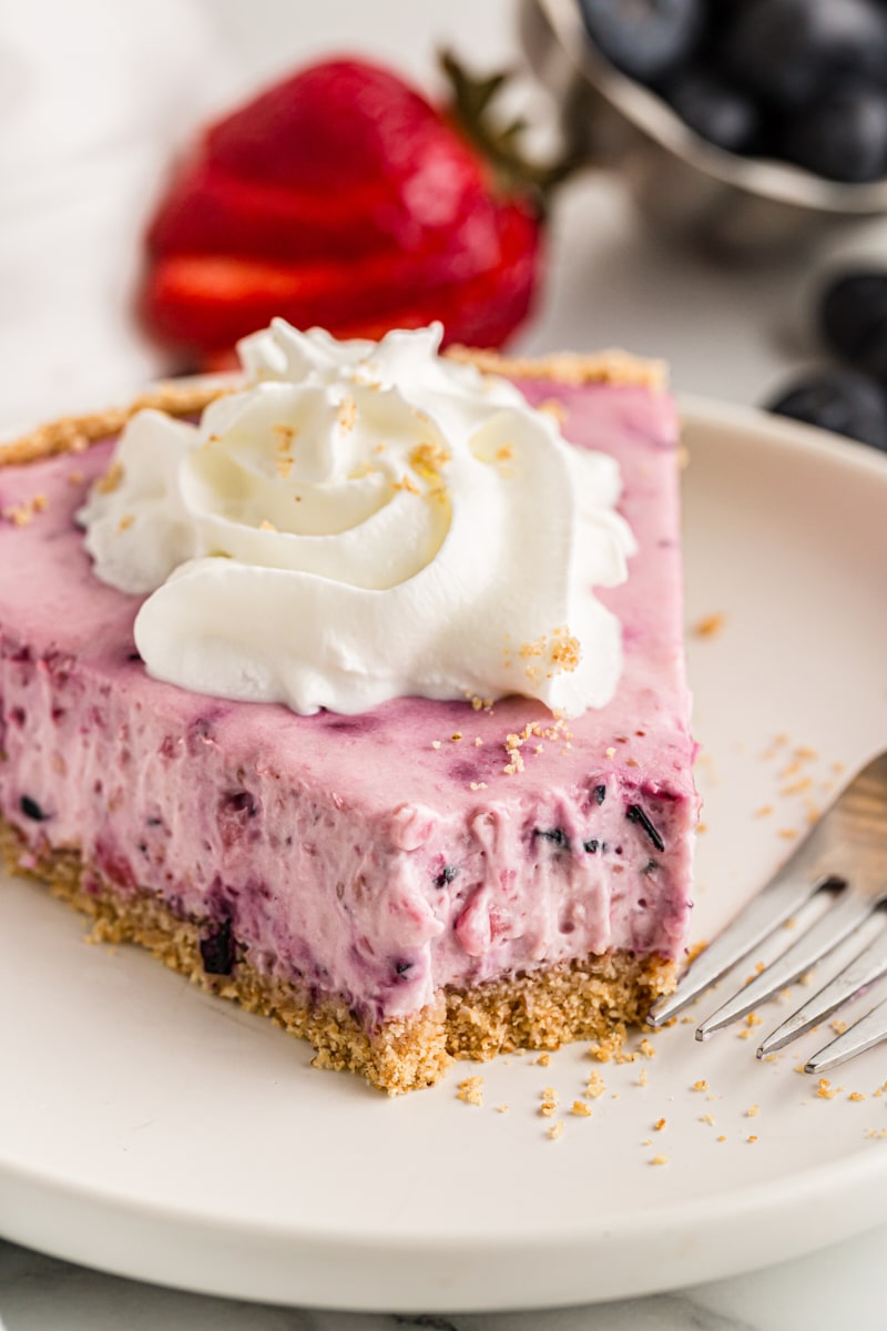 Berry cheesecake on plate, with tip eaten