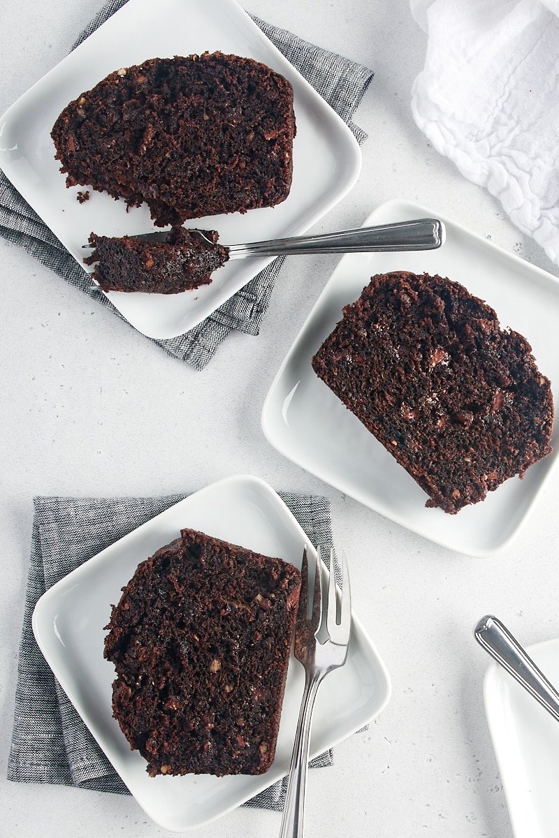 overhead view of slices of Chocolate Zucchini Bread on white plates