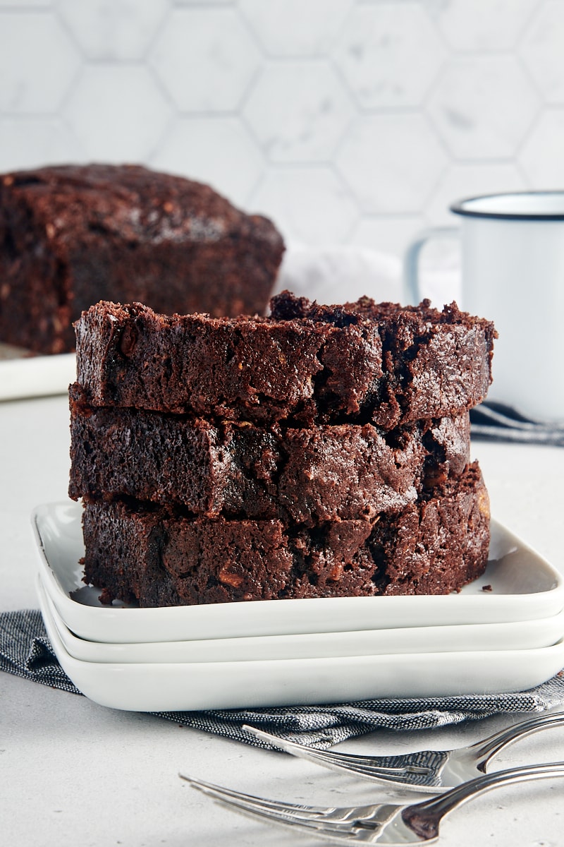 slices of Chocolate Zucchini Bread stacked on a white plate