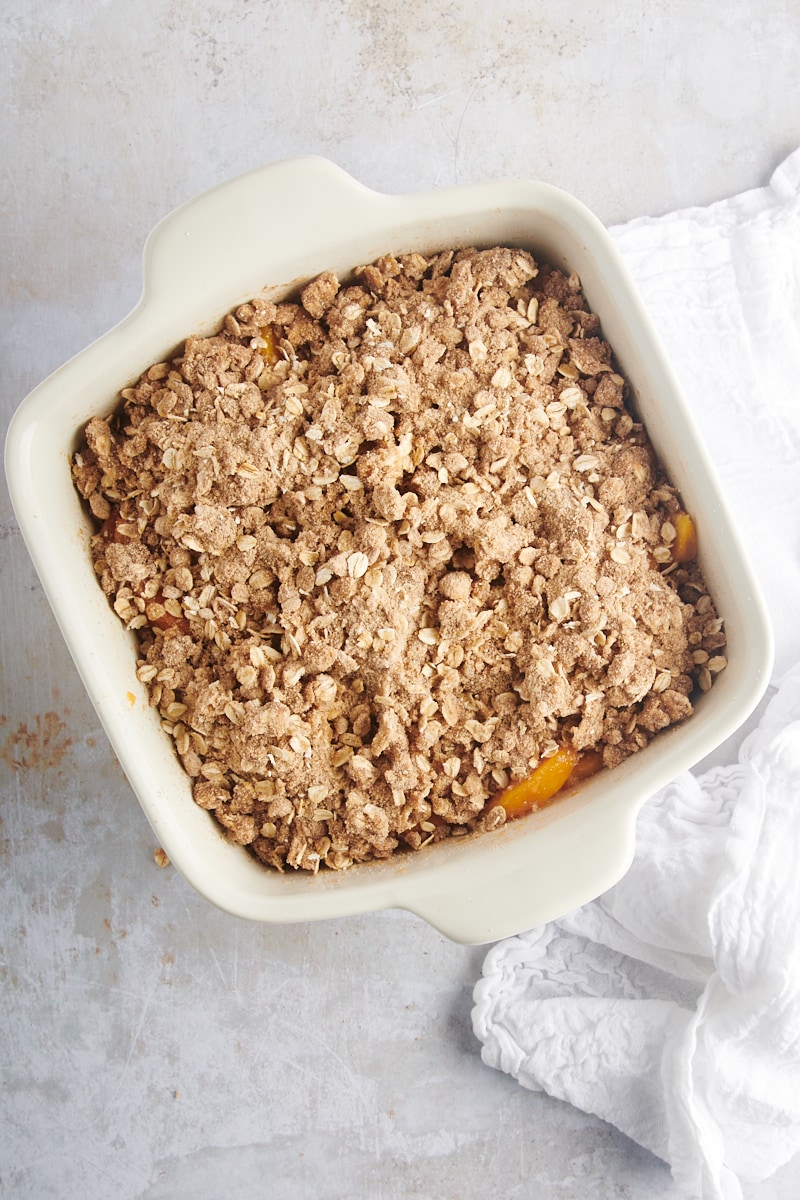 overhead view of assembled peach crisp ready to be baked