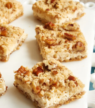 sliced Pecan Cheesecake Bars on a white serving tray