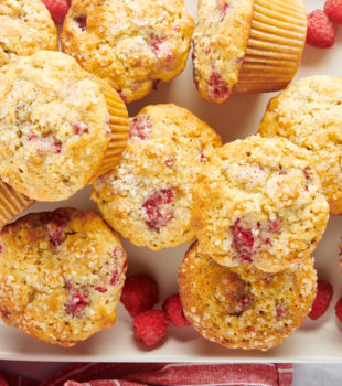 Overhead view of raspberry oat muffins stacked on tray