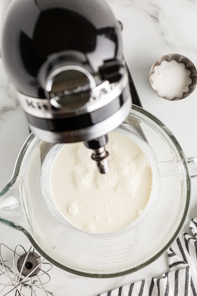 Overhead view of cream in stand mixer bowl