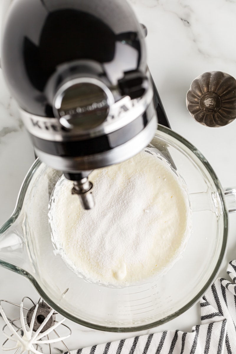 Overhead view of cream and sugar in stand mixer bowl