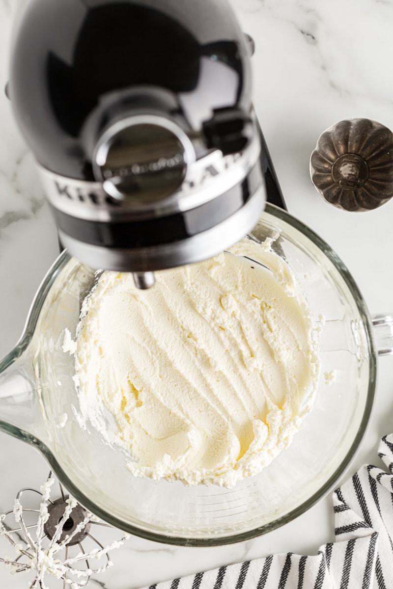 Overhead view of whipped cream in stand mixer bowl