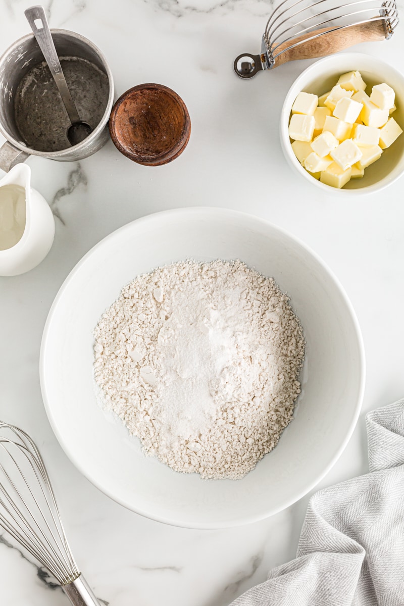 Overhead view of dry pie crust ingredients in a mixing bowl.