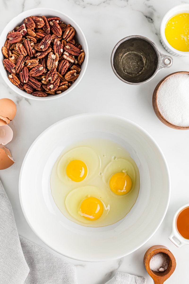 Overhead view of eggs in a mixing bowl.