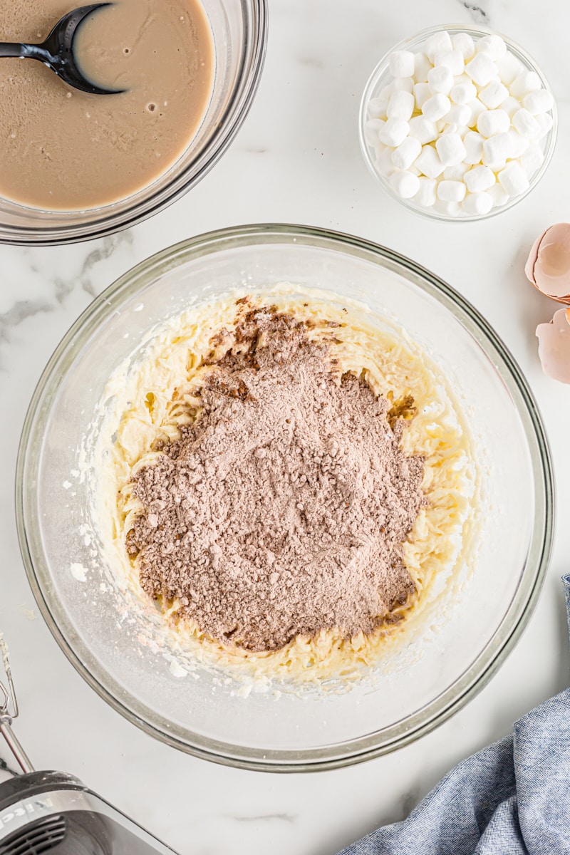 Adding dry ingredients to wet ingredients in mixing bowl