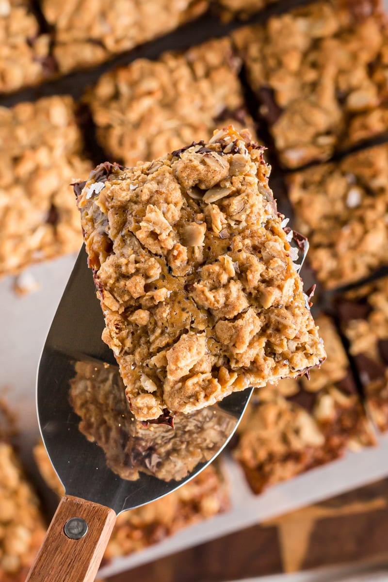 Spatula holding salty cashew caramel bar