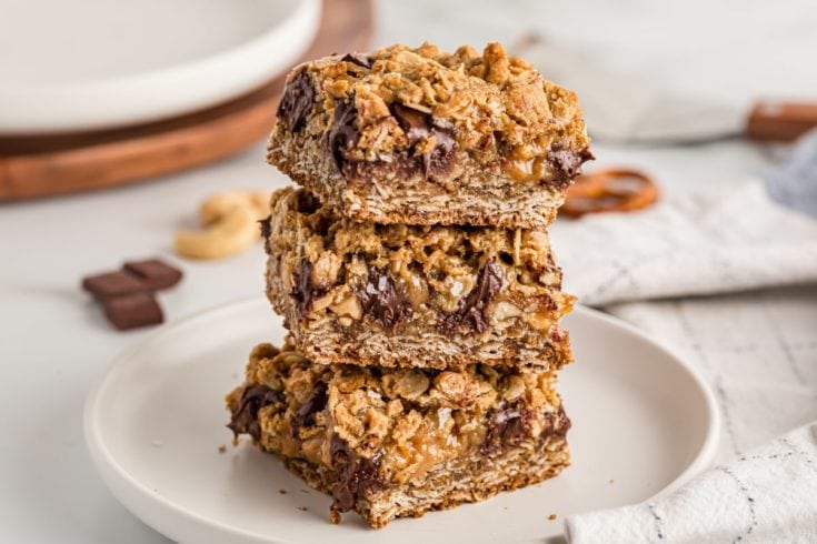 Stack of 3 salty cashew caramel bars on plate