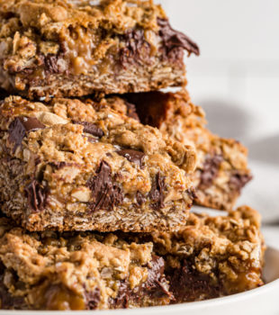 Stack of salty cashew caramel bars on plate