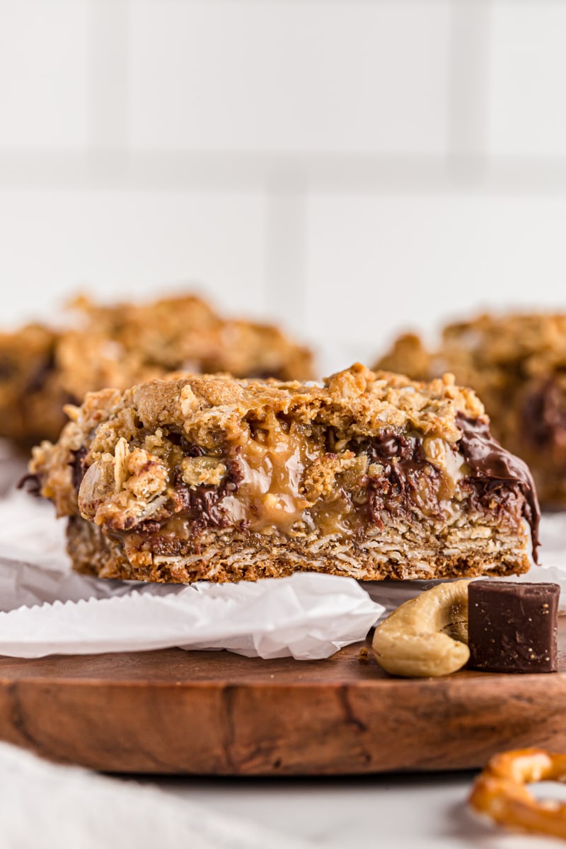 Salty cashew caramel bar on parchment-lined board