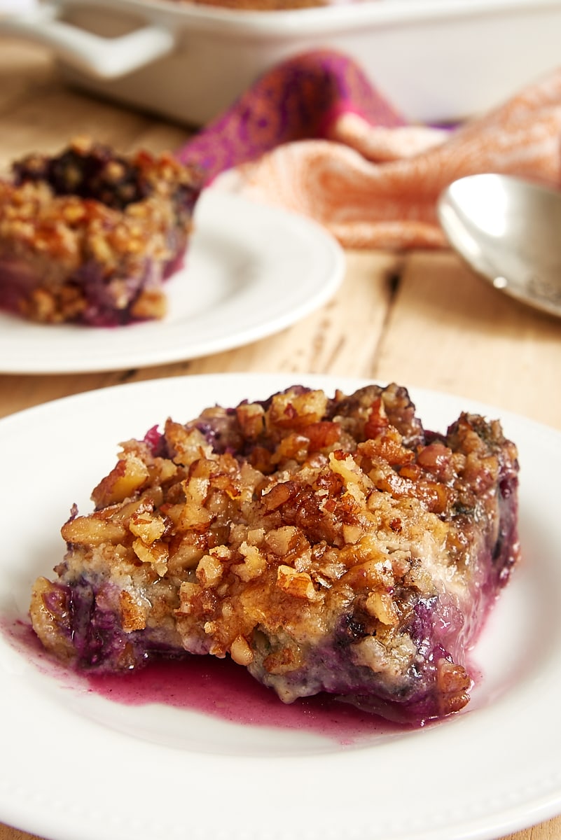 Serving of Blueberry Pineapple Dump Cake on a white plate.