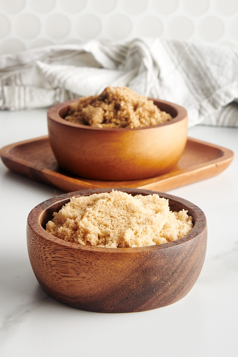 light and dark brown sugars in wooden bowls