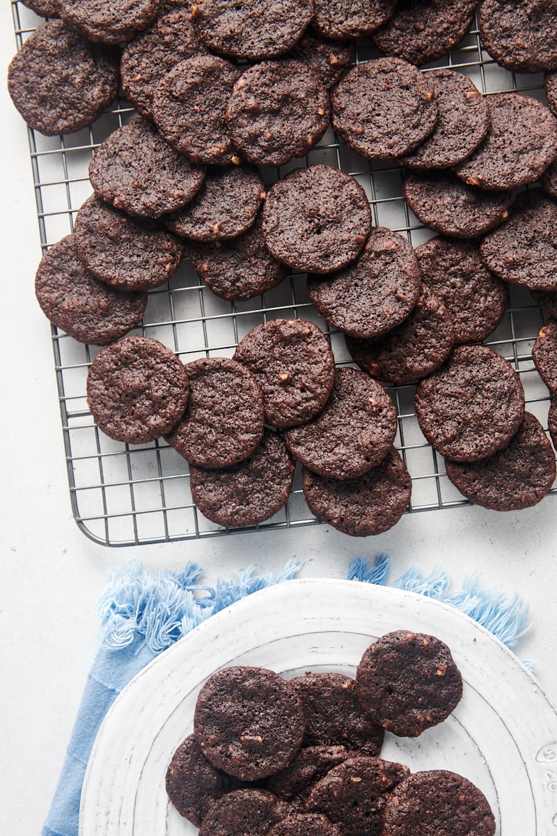Chewy chocolate cookies on cooling rack and plate