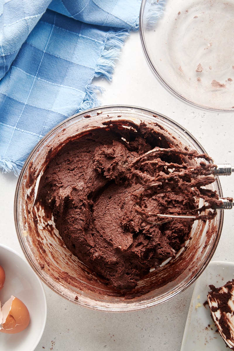 Chocolate cookie dough in mixing bowl with beaters