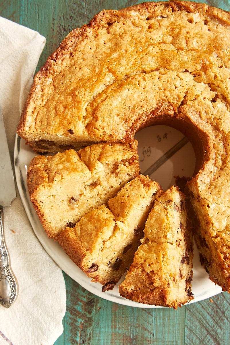 overhead view of partially sliced Chocolate Chip Cream Cheese Pound Cake on a white plate