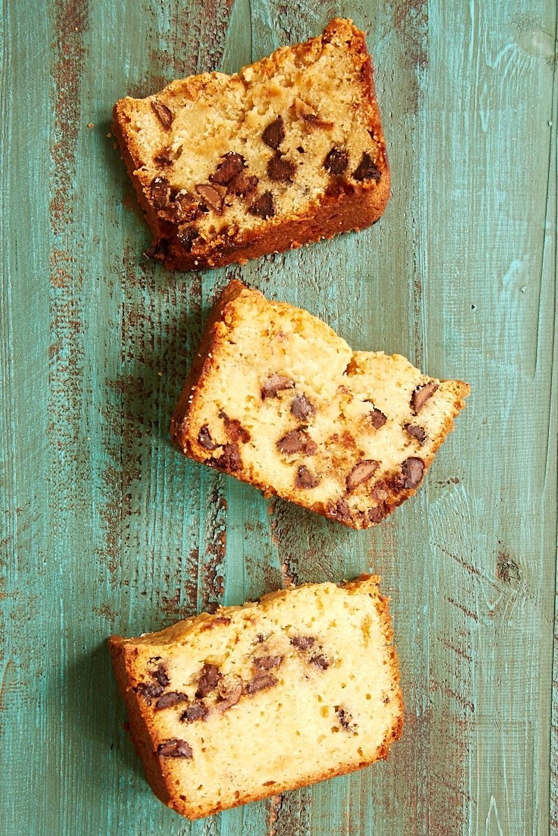 overhead view of three slices of Chocolate Chip Cream Cheese Pound Cake on a green wooden surface