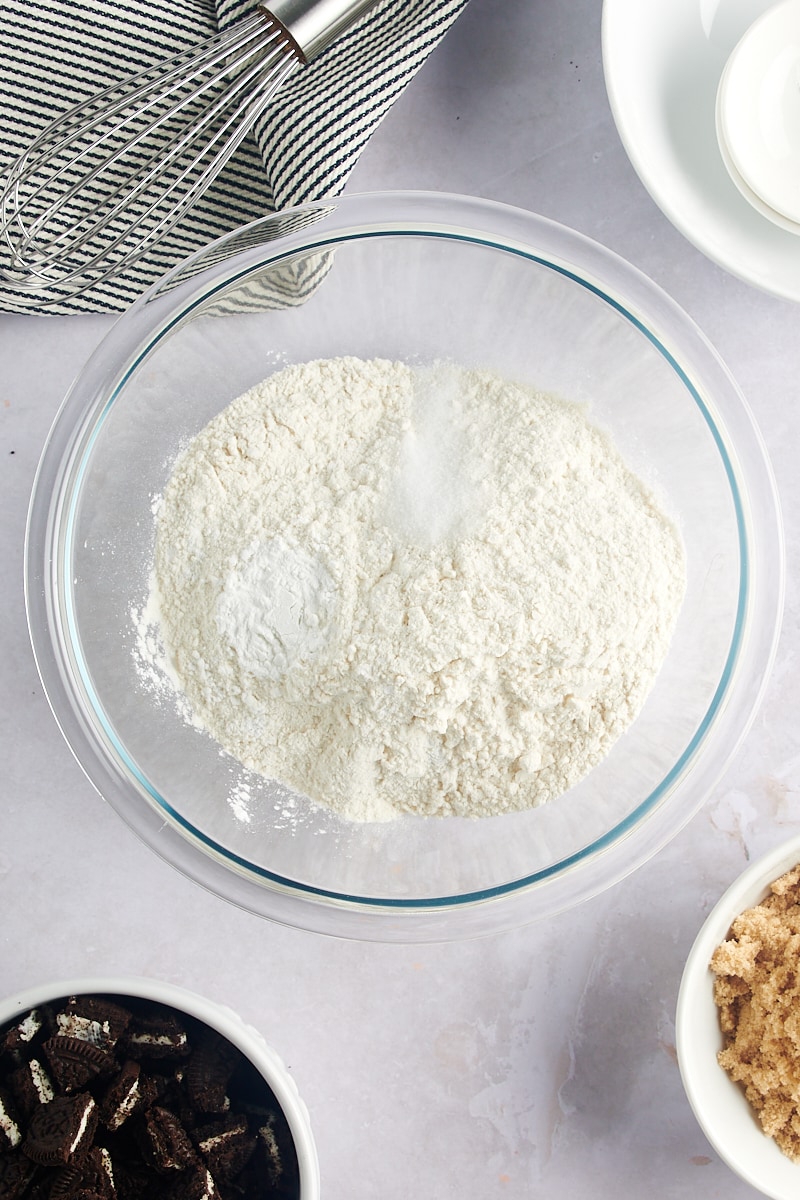 overhead view of flour, baking powder, and salt in a glass mixing bowl