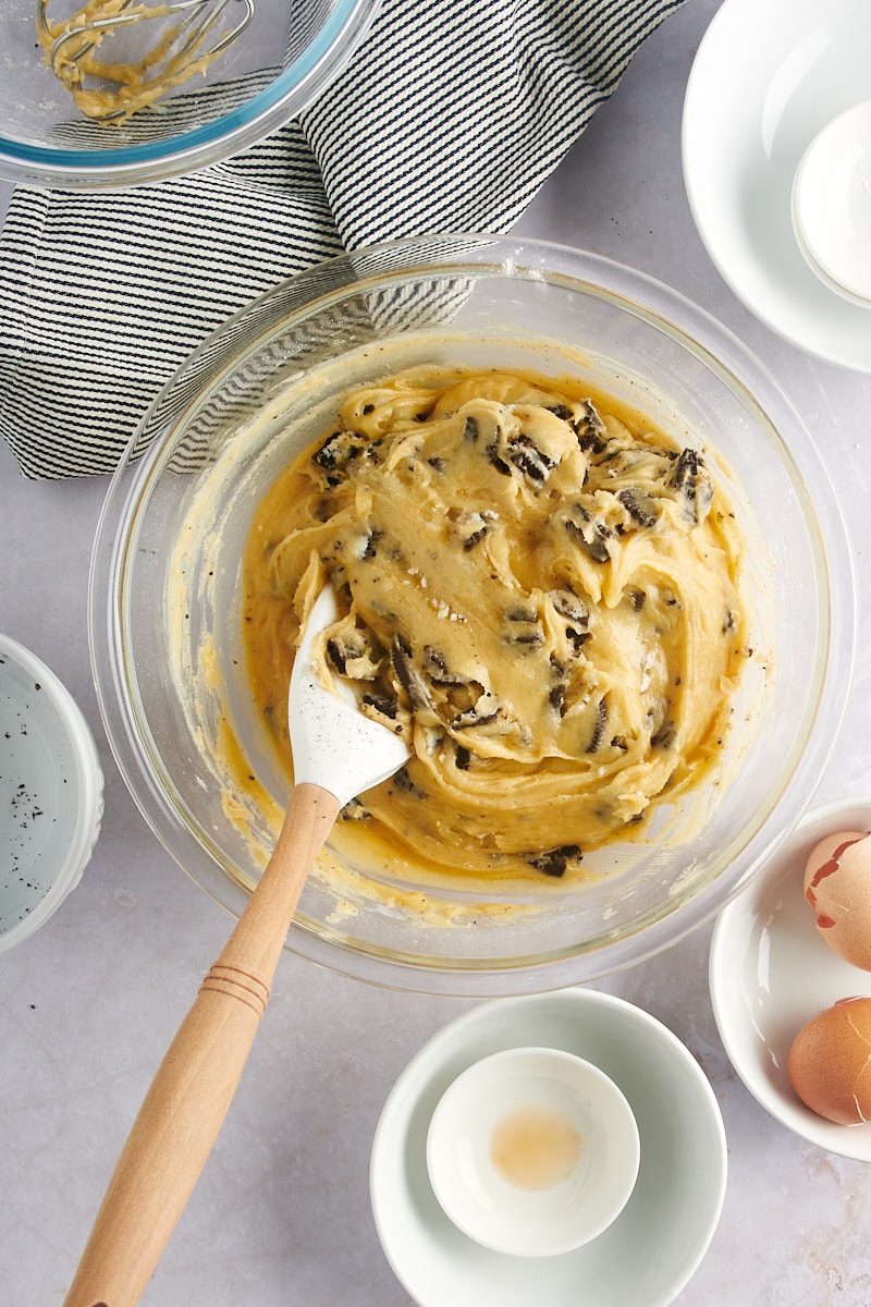 overhead view of mixed Cookies and Cream Blondies batter in a glass mixing bowl