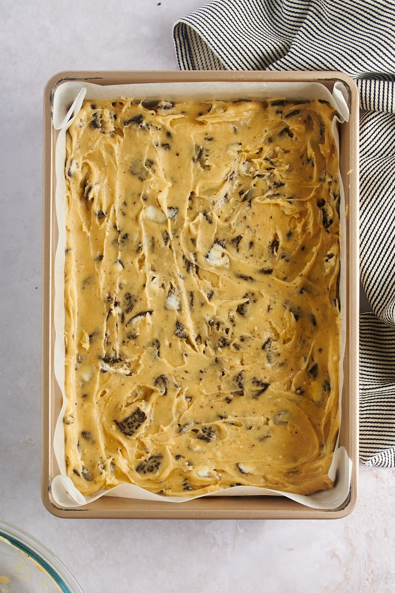 overhead view of Cookies and Cream Blondies batter spread in a 9" x 13" baking pan
