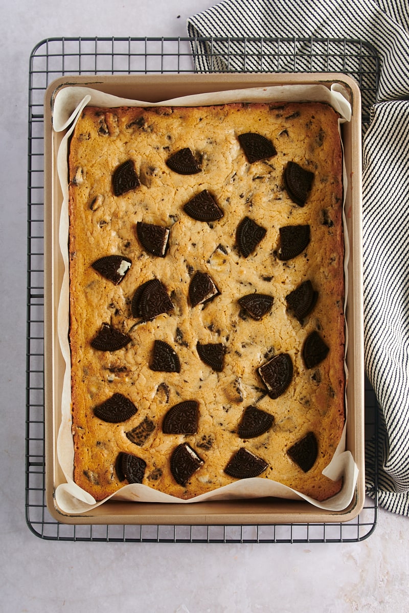 overhead view of freshly baked Cookies and Cream Blondies in a 9" x 13" baking pan on a wire rack