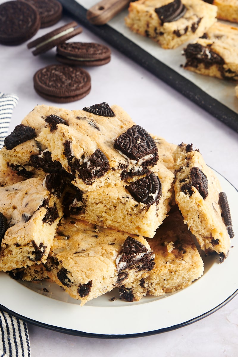 pile of Cookies and Cream Blondies on a black-rimmed white plate