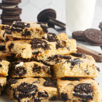 stacks of Cookies and Cream Blondies on parchment paper