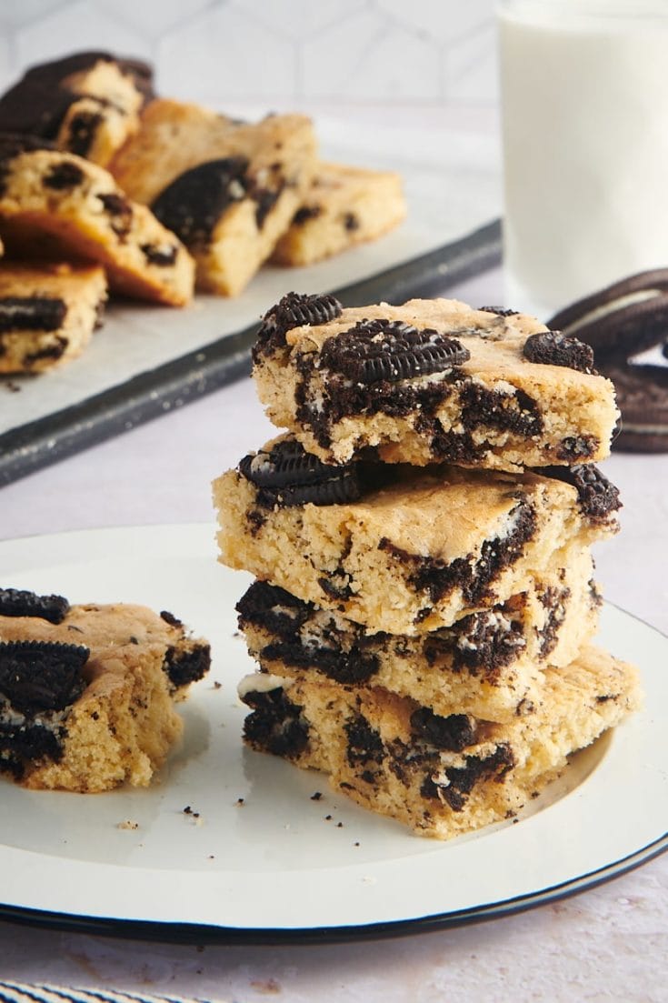 stack of Cookies and Cream Blondies on a black-rimmed white plate