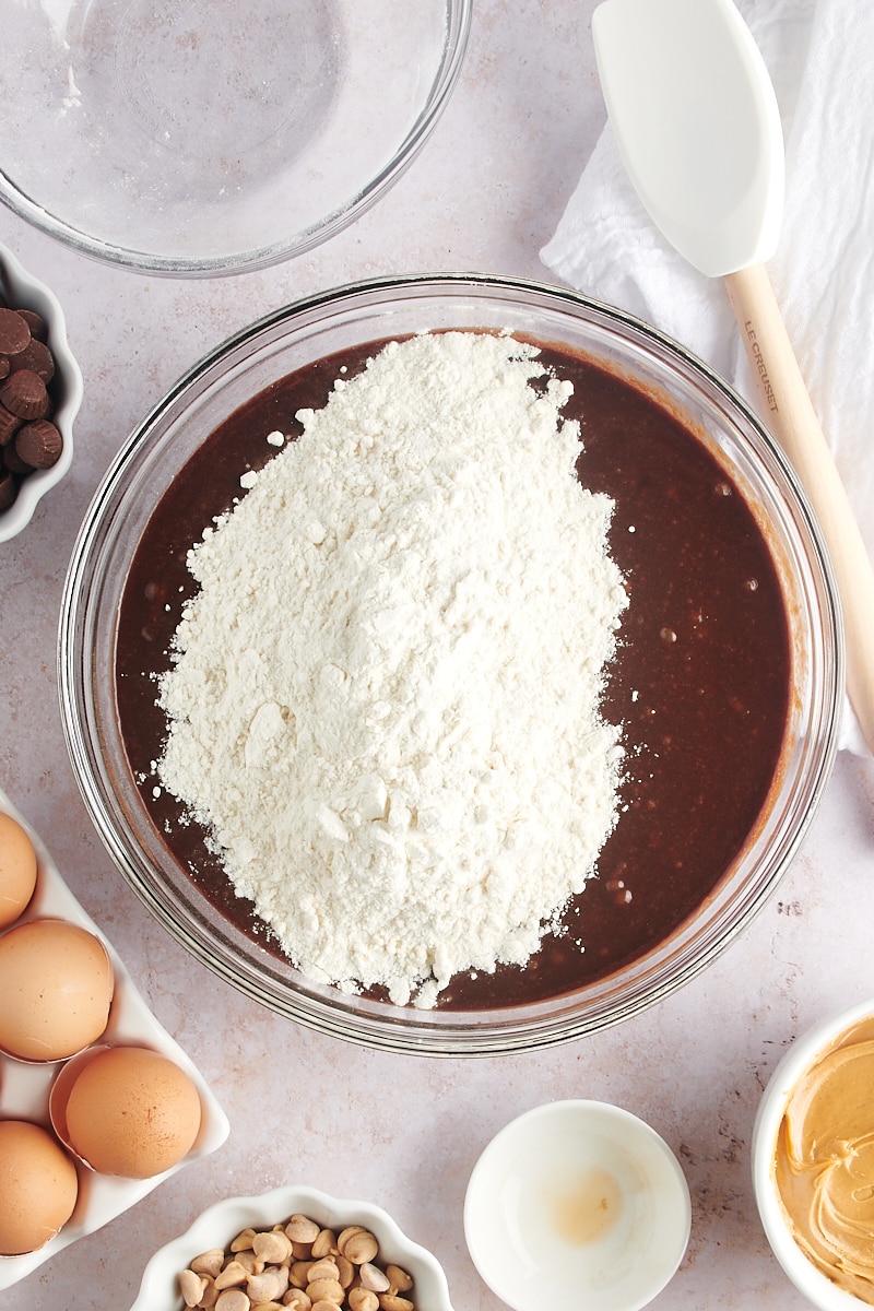 Overhead view of dry ingredients added to brownie batter