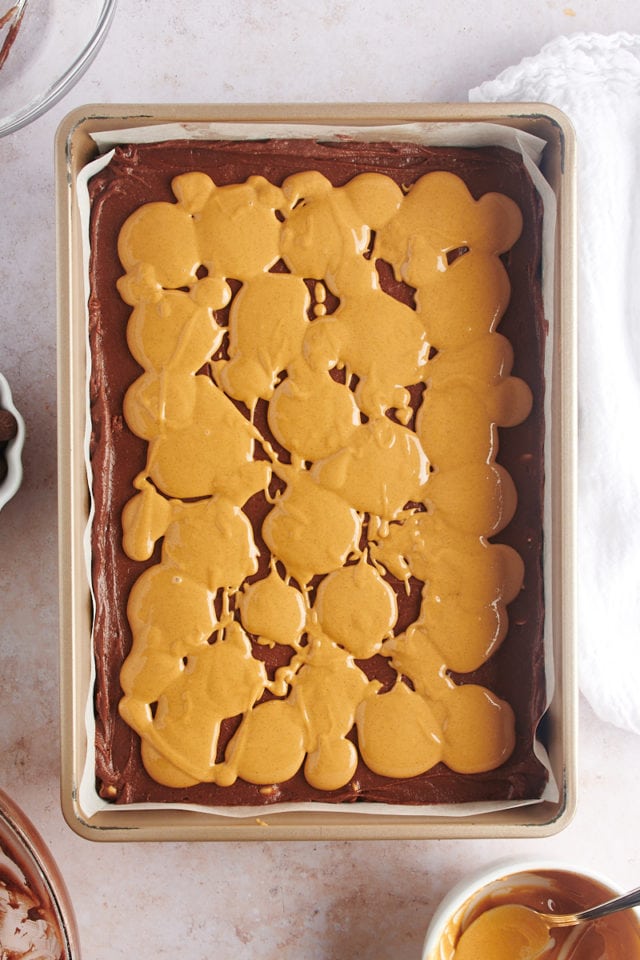 Overhead view of peanut butter on top of brownie batter