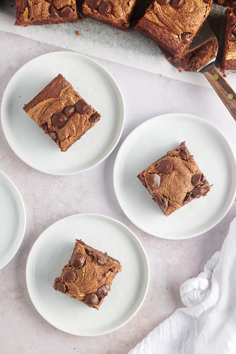 Overhead view of 3 peanut butter brownies on plates