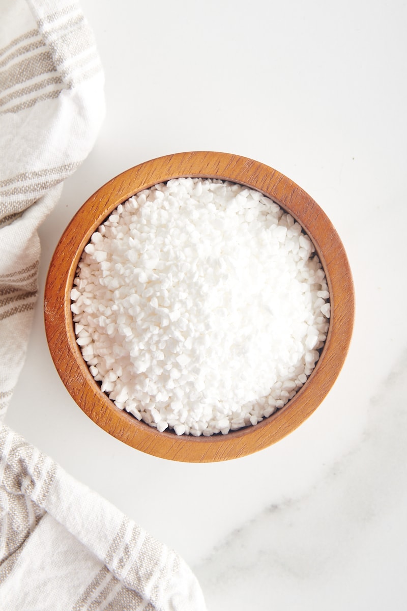 overhead view of pearl sugar in a small wooden bowl