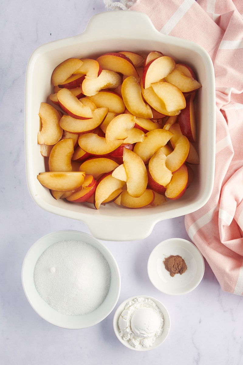 overhead view of sliced plums in a baking dish