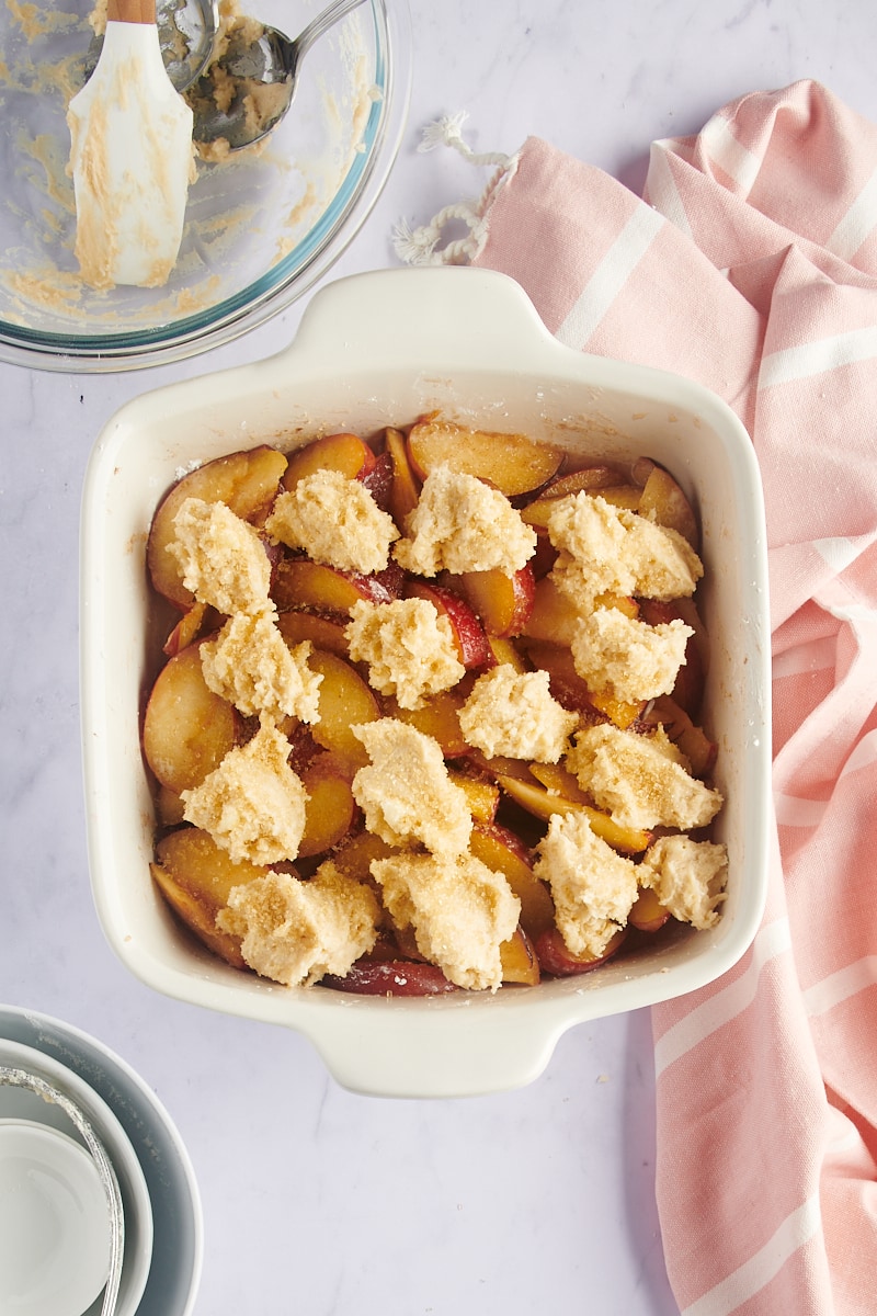 overhead view of plum cobbler ready to go in the oven