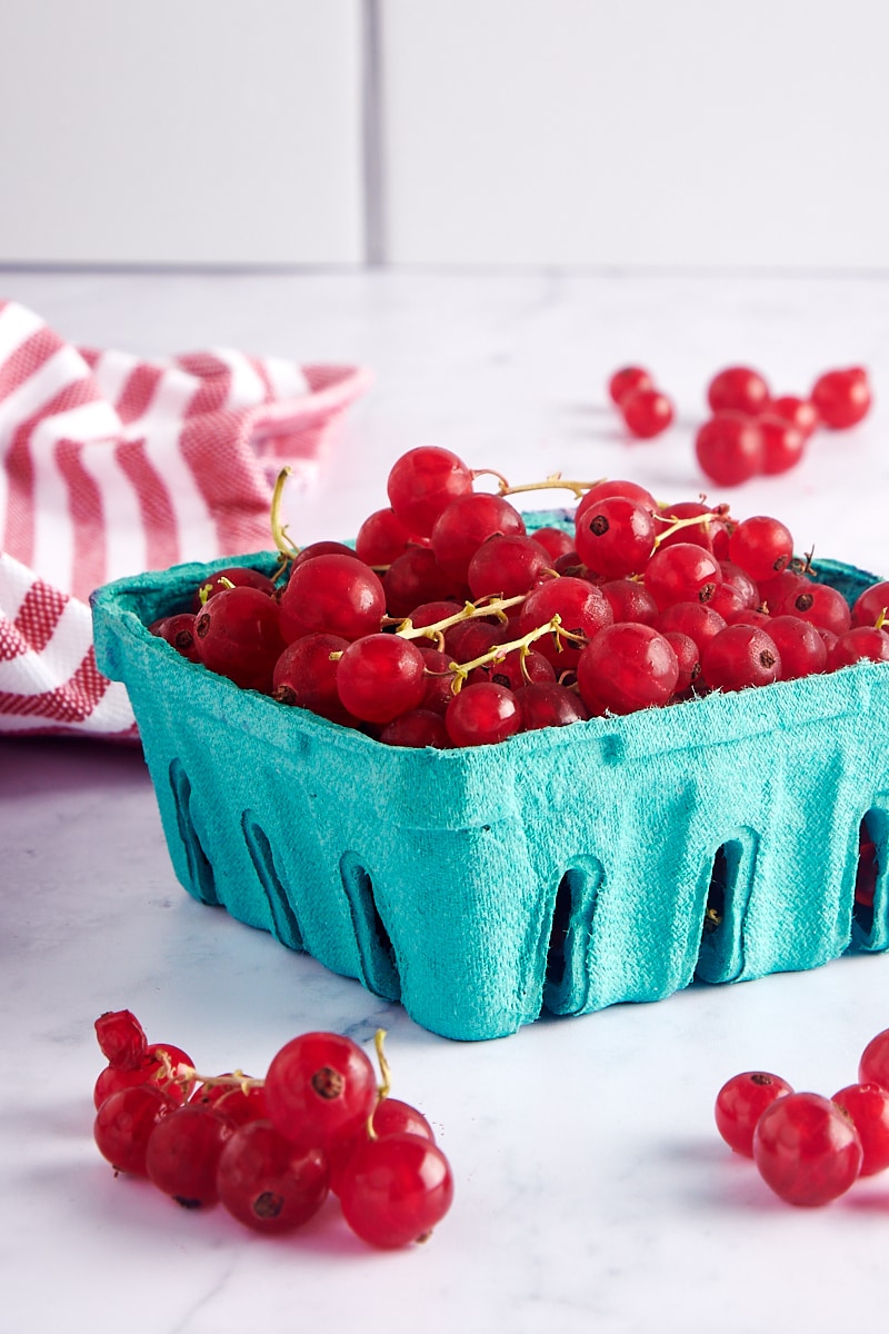 red currants in a green berry basket