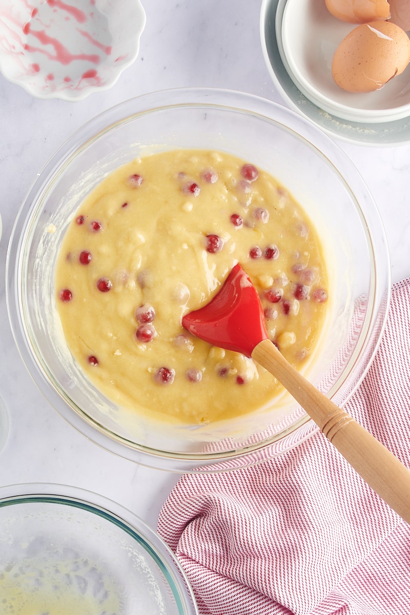 overhead view of mixed Red Currant Muffins batter in a glass mixing bowl