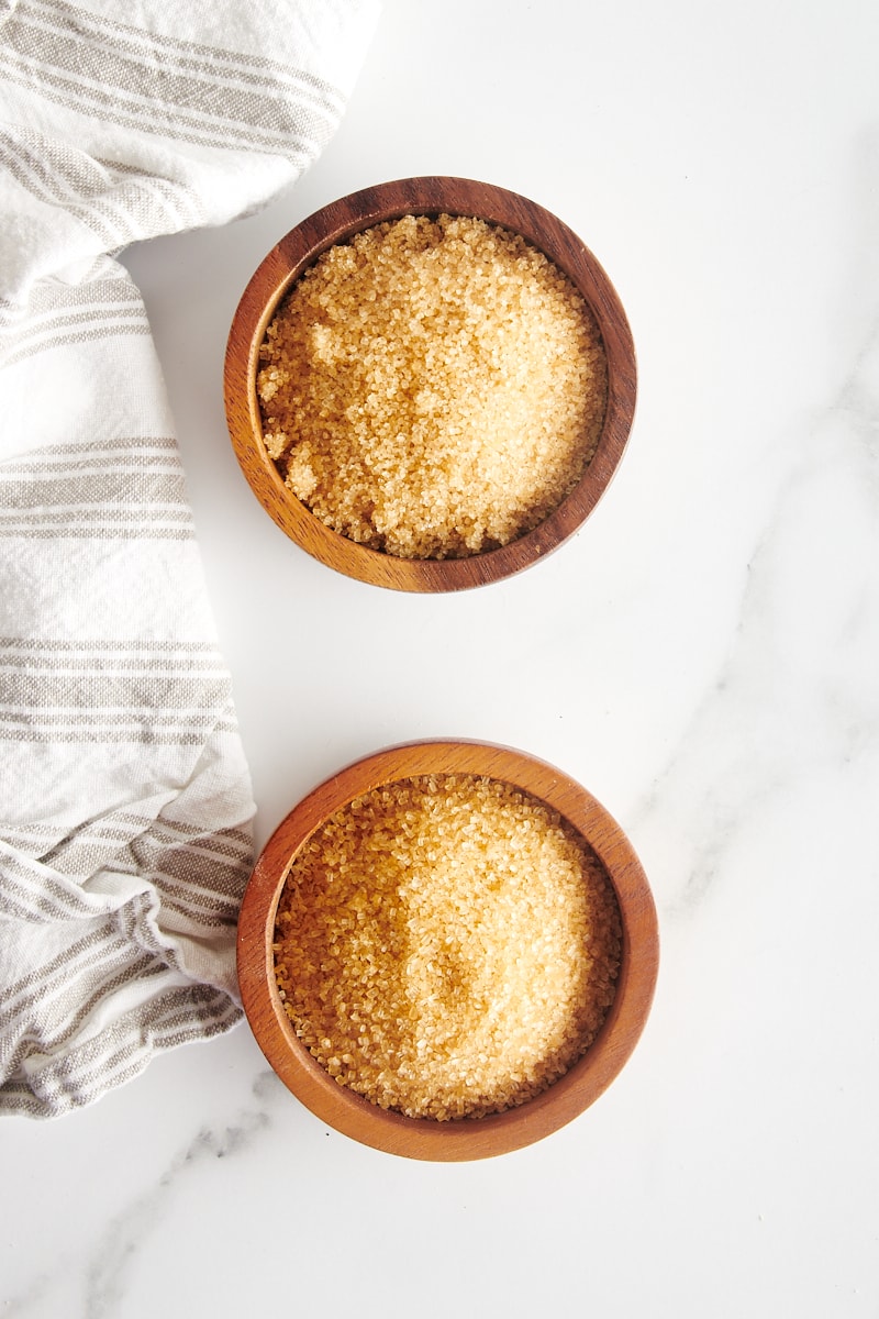 overhead view of turbinado sugar and demerara sugar in small wooden bowls