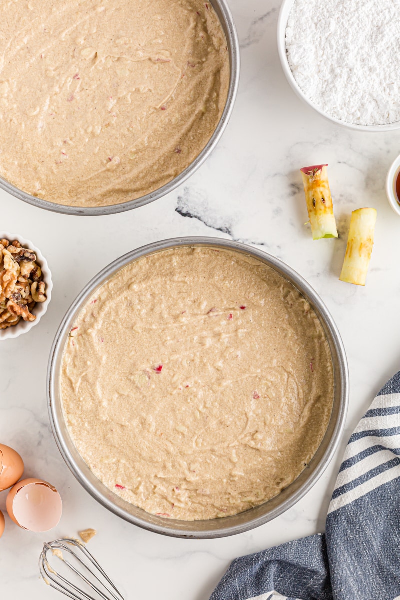 overhead view of apple spice cake batter in cake pans