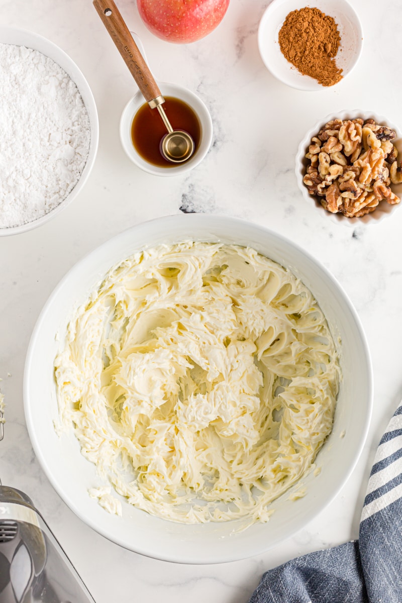 overhead view of mixed butter and cream cheese in a white mixing bowl