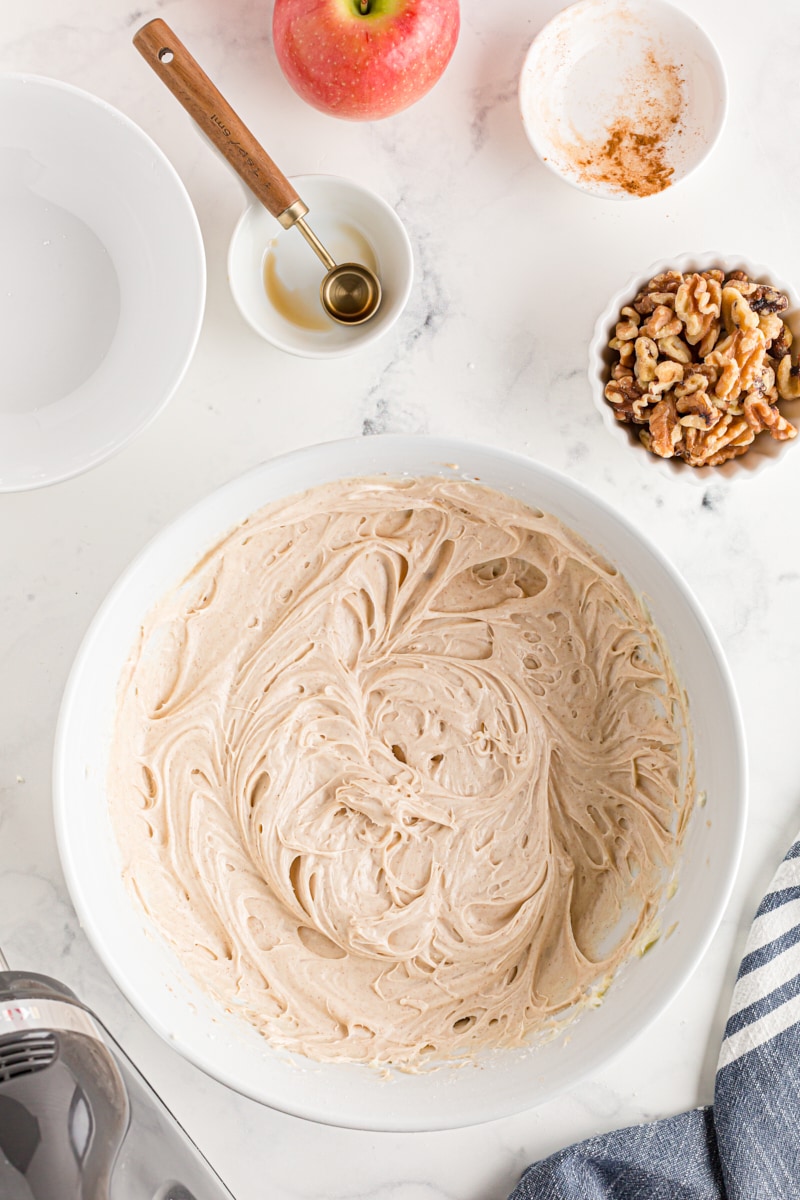 overhead view of cinnamon cream cheese frosting in a white mixing bowl