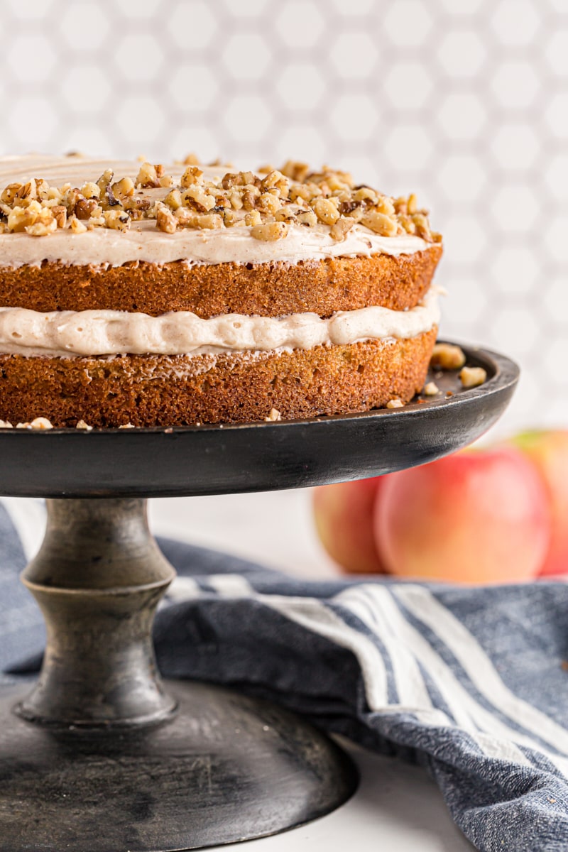 Apple Spice Cake with Cinnamon Cream Cheese Frosting on a black cake stand