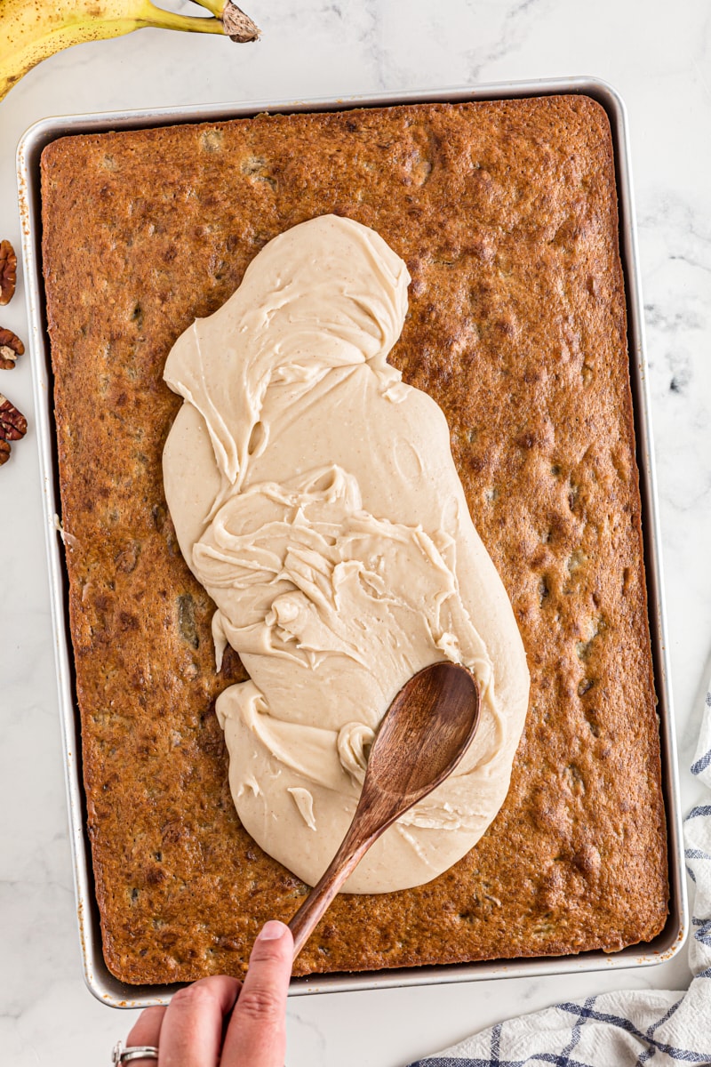 Spreading icing onto banana bars in pan