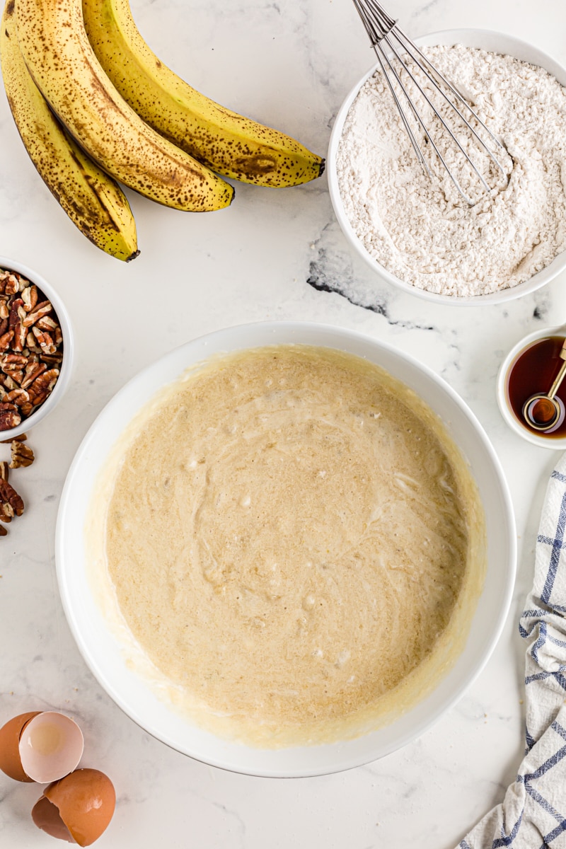 Overhead view of wet ingredients for banana bars in mixing bowl