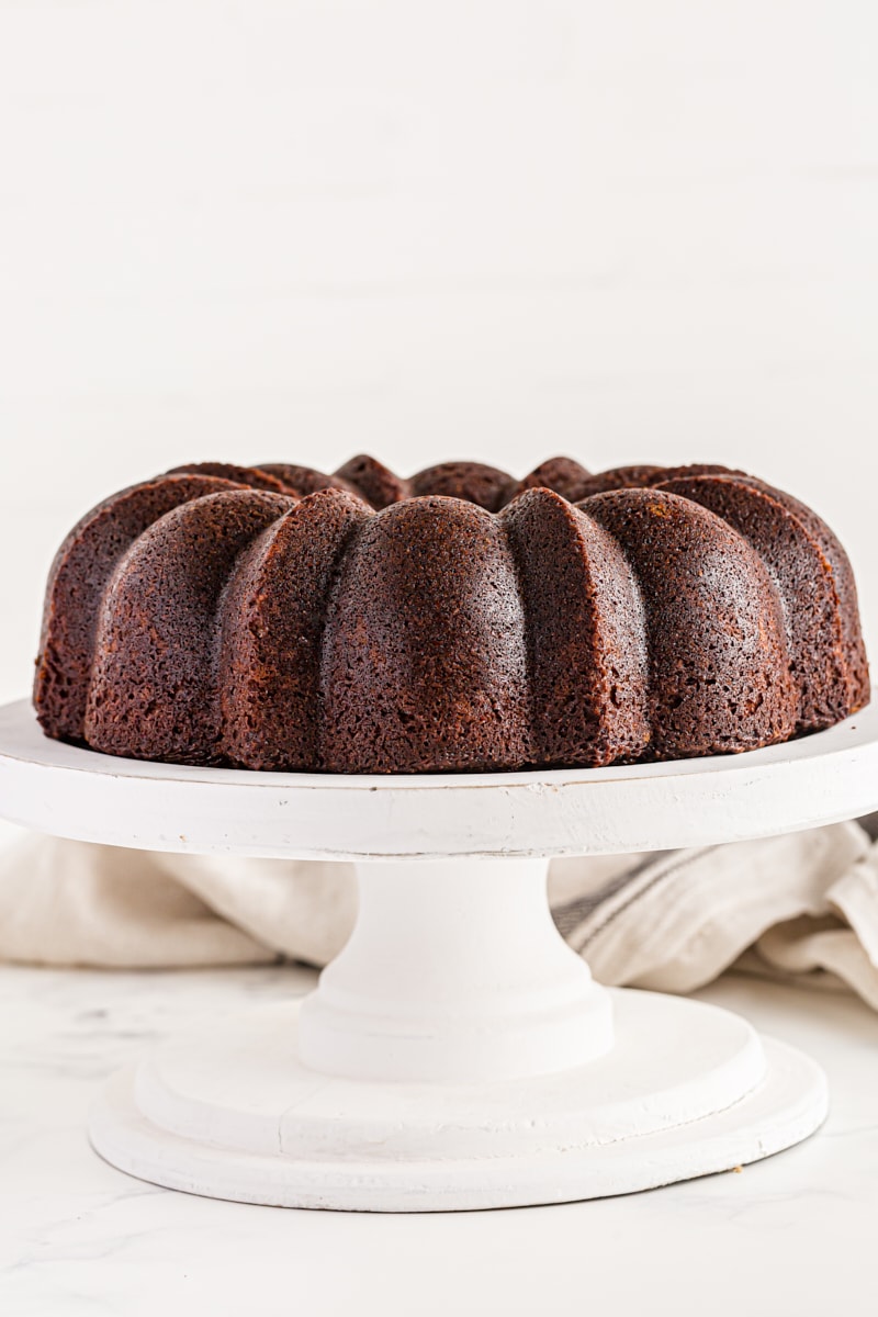 Whole chocolate amaretto bundt cake on cake stand