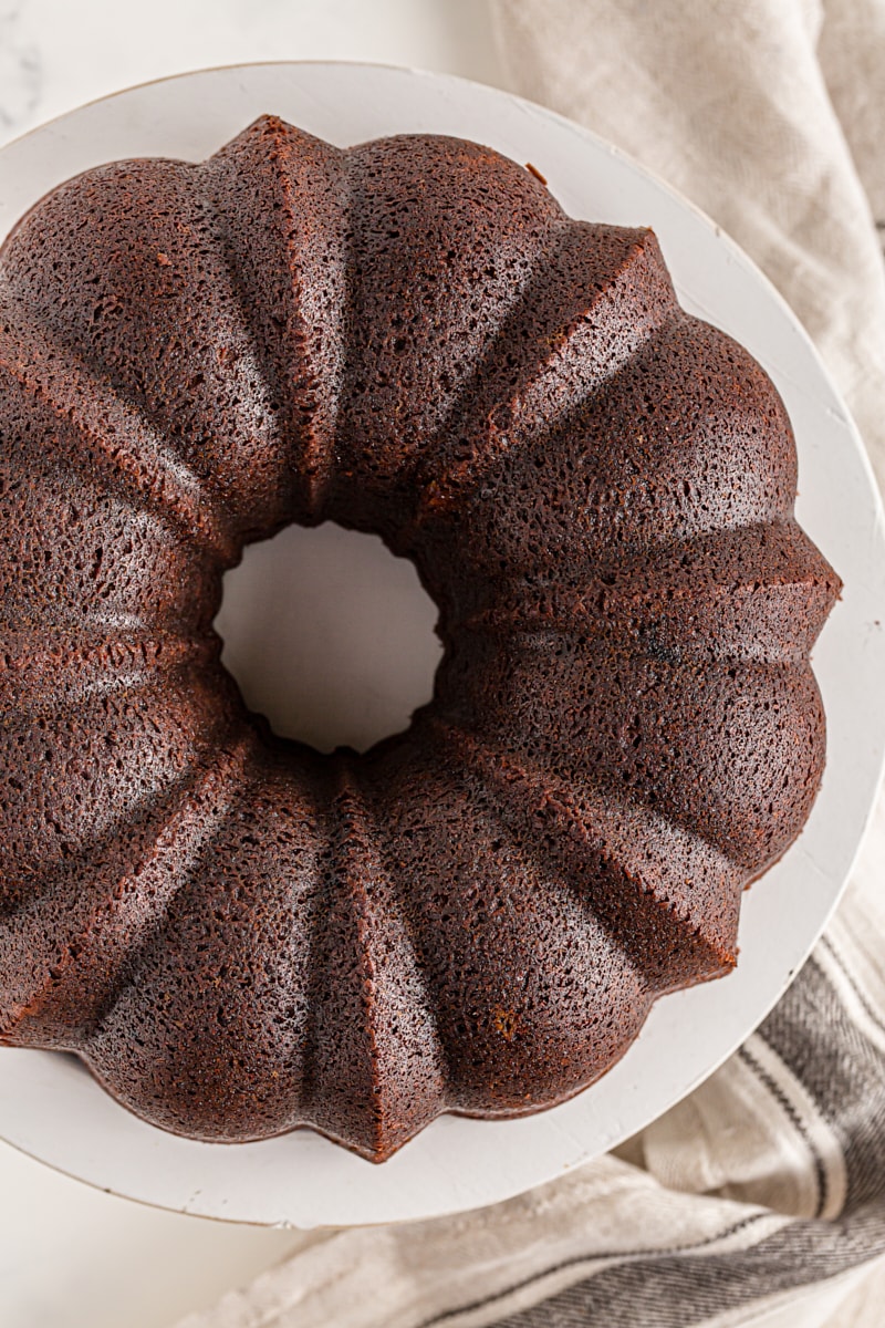 Whole chocolate amaretto bundt cake on cake stand