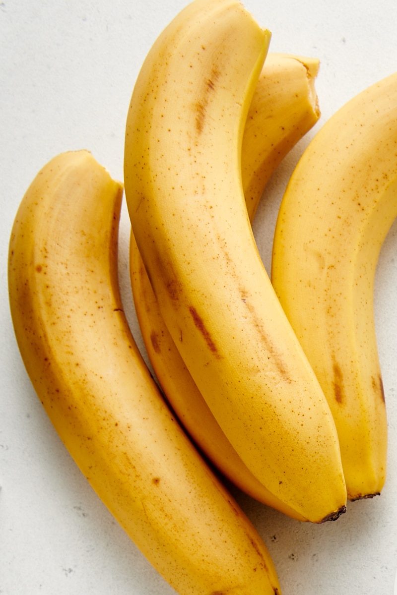 four bananas on a white countertop